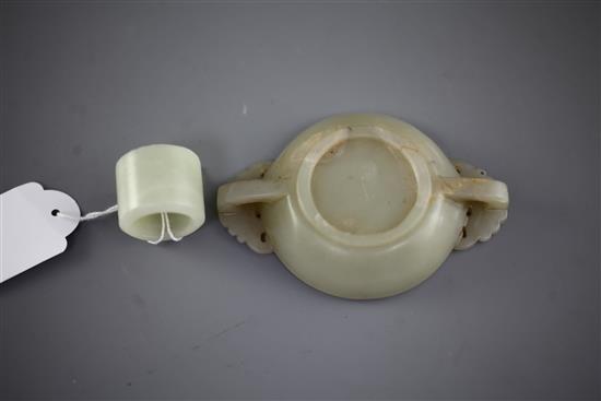A Chinese pale celadon jade small brush washer and an archers ring, 2.7cm and 10.2cm